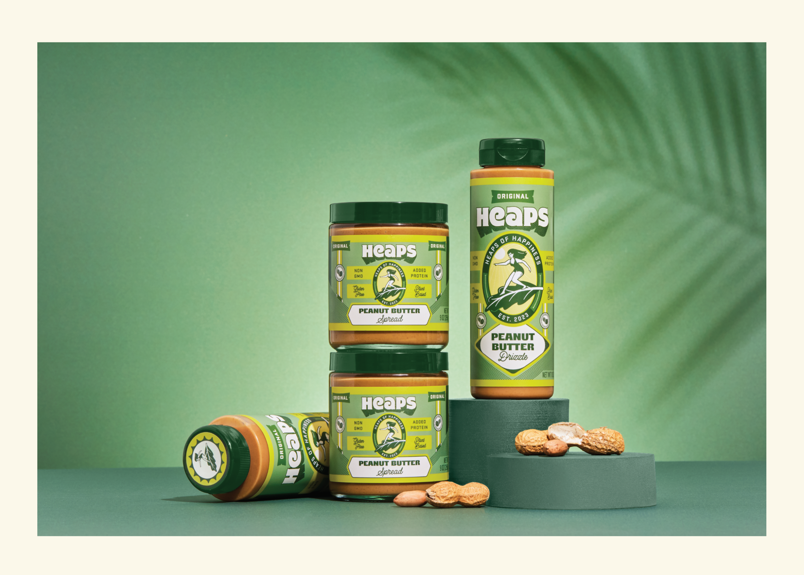 Heaps brand peanut butter products on a green background with a palm leaf shadow.